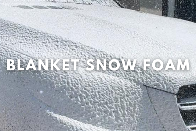 Step 1: Blanket snow foam applied to a car, ensuring thorough surface cleaning with a snowy backdrop.